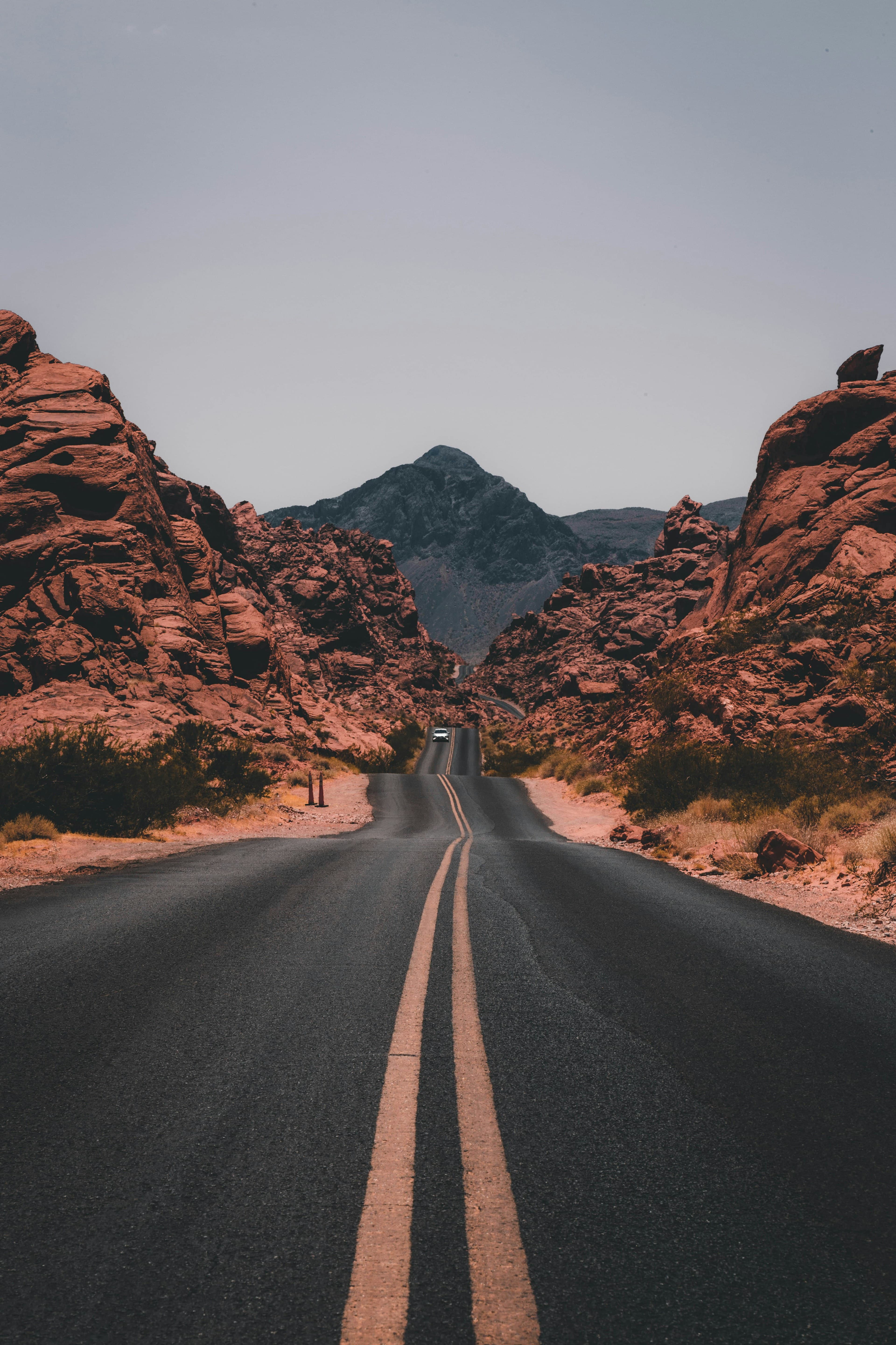 A two-lane road running between red rock canyon walls.
