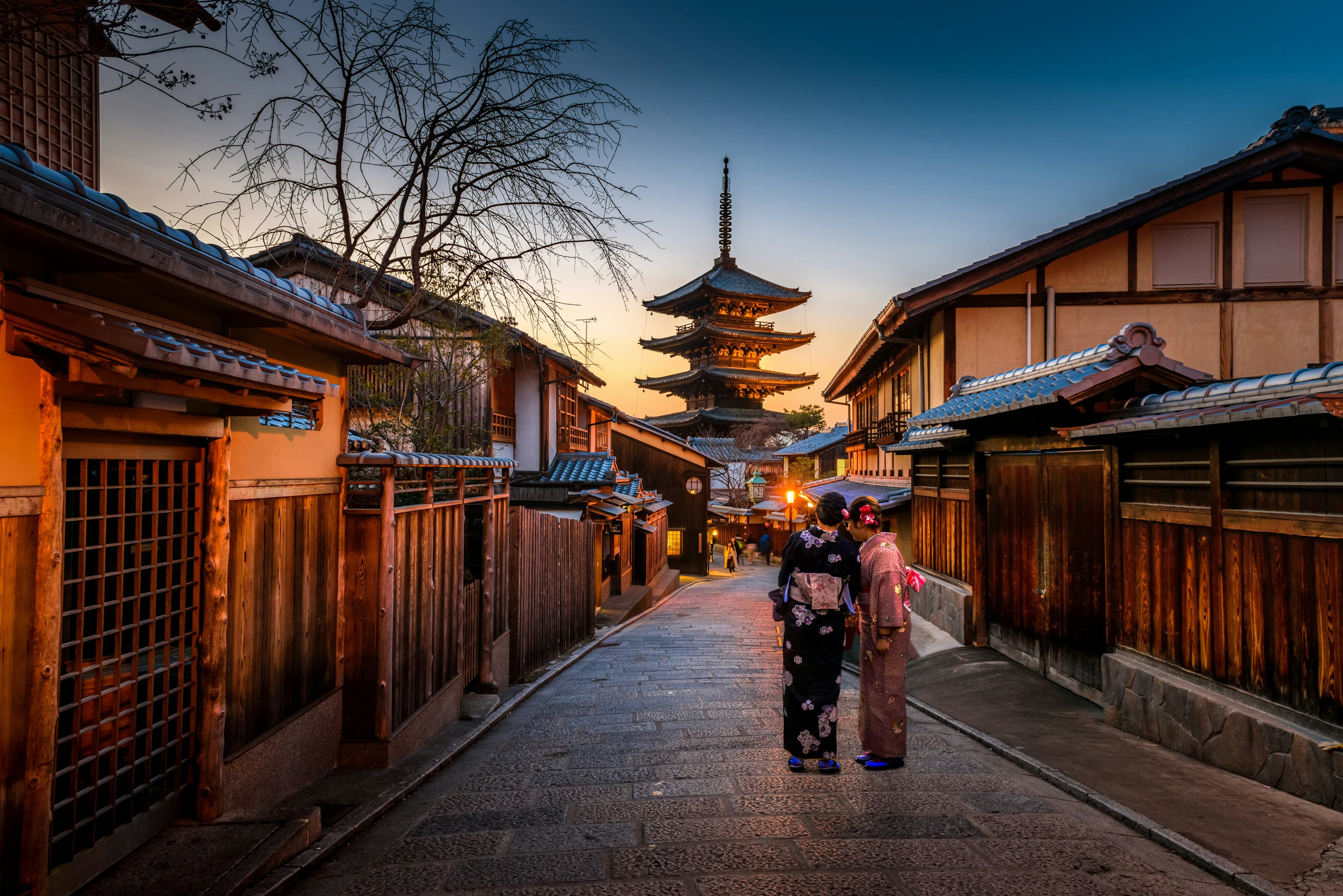 A Kyoto street with a pagoda at dusk, clean and bright.
